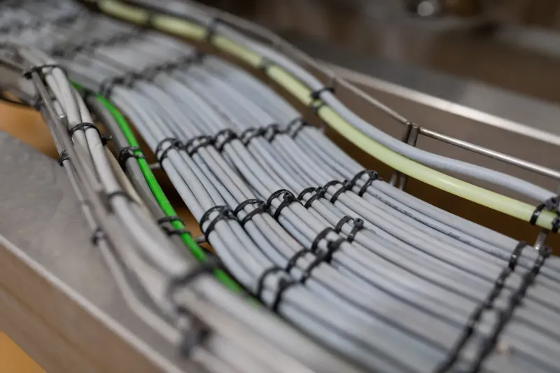 Neatly arranged electrical cables secured along an installation tray